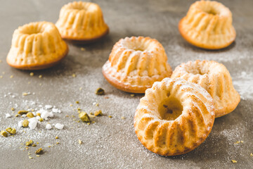Homemade delicious mini lemon bundt cakes (muffins) on gray concrete background