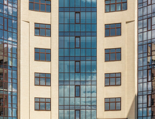 Facade windows of modern multi-storey brown beige building in the city. Space for text. High quality photo