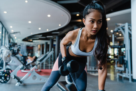 Beautiful Young Asia Lady Exercise Doing Lifting Barbell Fat Burning Workout In Fitness Class. Athlete With Six Pack, Sportswoman Recreational Activity, Functional Training, Healthy Lifestyle Concept.