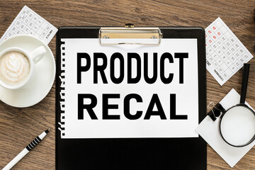 Product Recall, text on wood table, on white paper