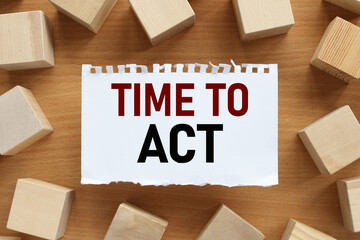 Time To ACT text on white paper on wood cubes background