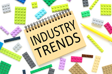 Industry Trends, text on a craft notebook near the constructor of different colors