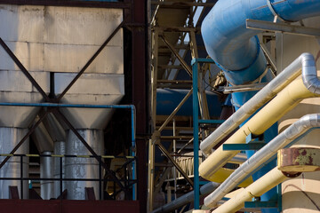 Industrial zone with tubes and factory chimneys.