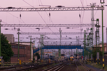 Railway station at dawn. Purple sky.