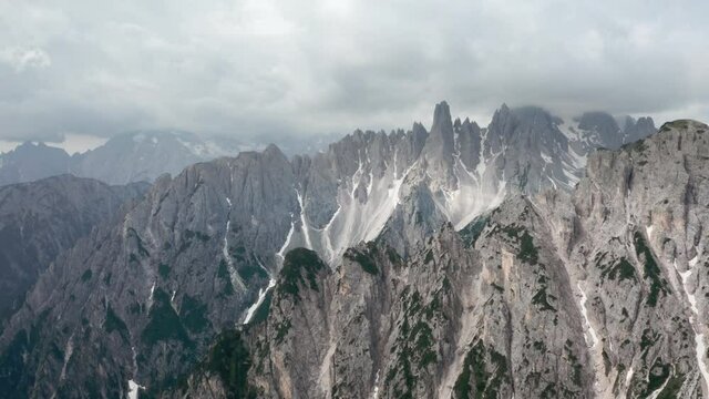 4K aerial footage of a picturesque Dolomite Alps ridges and peaks. Drone point of view flying up at cca 3000m near Tre Cime di Lavaredo, northeastern Italy.