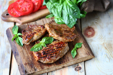 Grilled juicy steaks on a wooden surface. Steak house menu.