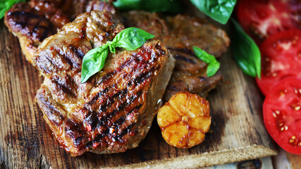 Grilled juicy steaks on a wooden surface. Steak house menu.