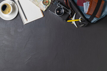 Prepare a suitcase,  vintage camera,  notebook, map and black coffee