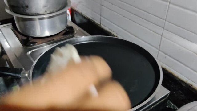 Cooking rice dish (Rotti Appam) in a frying pan or Nonstick flat tawa