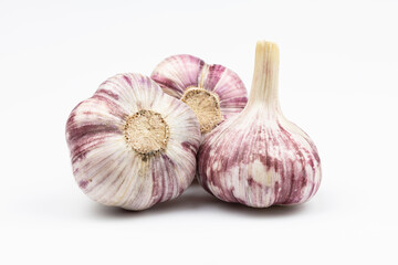 Three heads of garlic isolated on a white background.