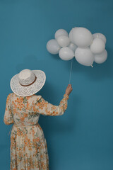 Cloudy day. Concept with woman and white baloons