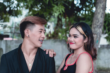 Two close friends look each other in the eye. A platonic and happy relationship between opposite...