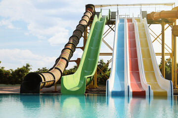 Beautiful view of water park with colorful slides and swimming pool on sunny day