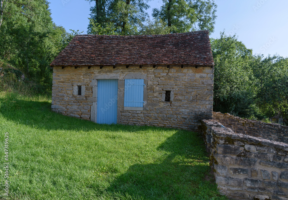 Wall mural old shed with blue door in the countryside