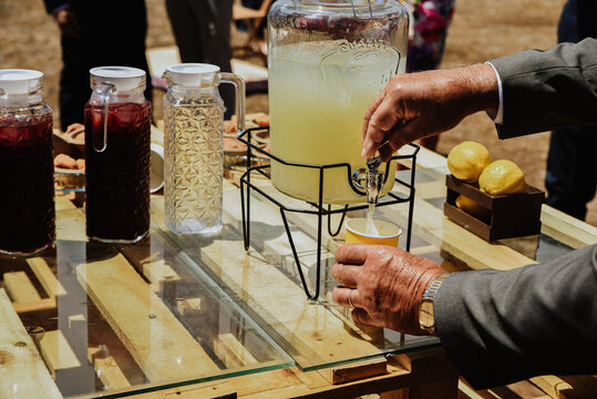 Man pouring fresh lemonade at the cafe