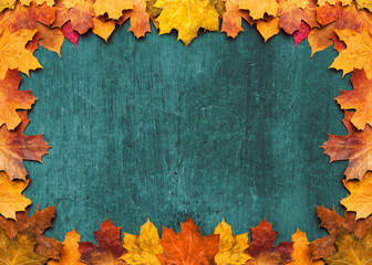 Naklejka na ściany i meble Autumn maple leaves on ancient texture. Falling leaves natural background. Seasonal background.