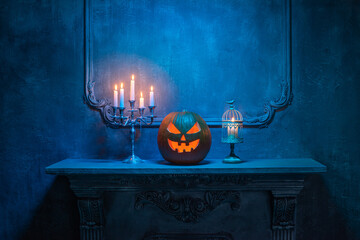 Scary laughing pumpkin and old skull on ancient gothic fireplace. Halloween, witchcraft and magic.