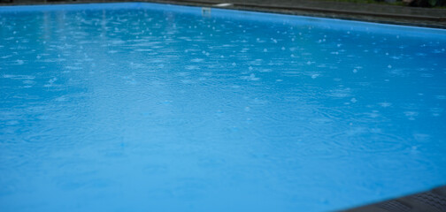 Fototapeta na wymiar Swimming pool with raindrops. Autumn season