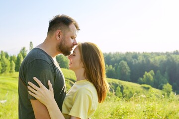 Happy adult couple in love. Man and woman in profile, romantic kiss