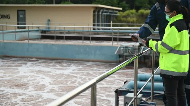 Environmental engineers work at wastewater treatment plants,Water supply engineering working at Water recycling plant for reuse,Technicians and engineers discuss work together.