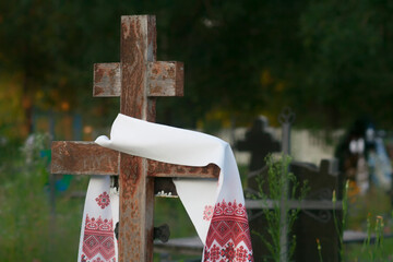 Wooden cross with white embroidered towel.Christian religion concept background.