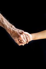 Old and young hold hands