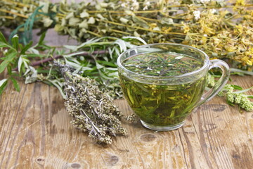 Wormwood bitter (Artemisia absinthium L.) tea drink. Wormwood is used in folk medicine,cooking,and the perfume industry. - obrazy, fototapety, plakaty