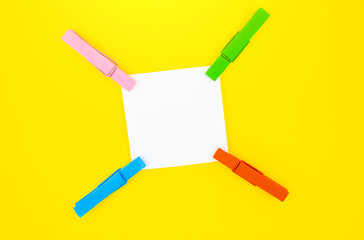 Blank white To Do List Sticker with colorful wooden clothespins. Close up of reminder note paper on...