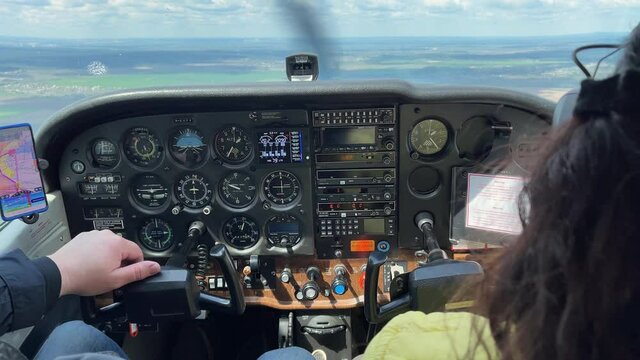 4k Man and woman flying small airplane. Pilots in a cockpit