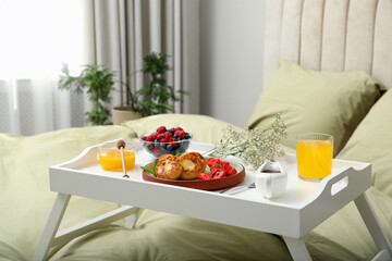Tasty breakfast served in bedroom. Cottage cheese pancakes with fresh berries and mint on white tray