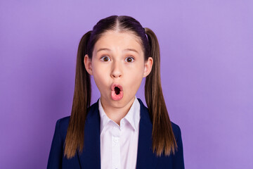 Photo of impressed shocked schoolgirl dressed blue uniform big eyes isolated violet color background