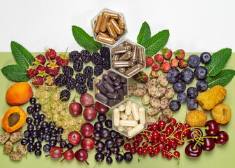 Pills and capsules with dietary supplements or vitamines and various berries