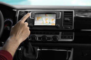 Man using navigation system while driving car, closeup