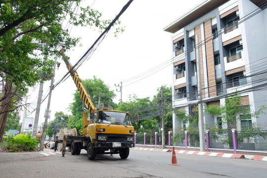 electricians repairing wire of the power line on electric power pole