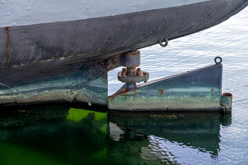 rudder of an old freight ship with reveted hull