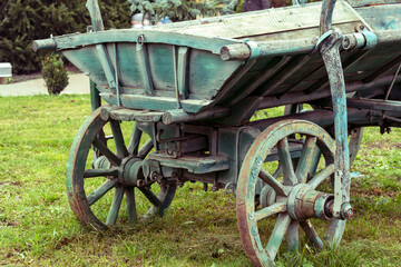 Fototapeta na wymiar Antiquarian transport. Old wooden two-wheeled cart, vehicle