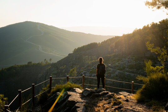 Woman looking at nature and mountain landscape from a viewpoint in Mondim de Basto, Norte, Portugal