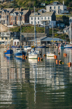 Boats moored in Looe's pretty harbour at dawn in spring, Looe, Cornwall, England