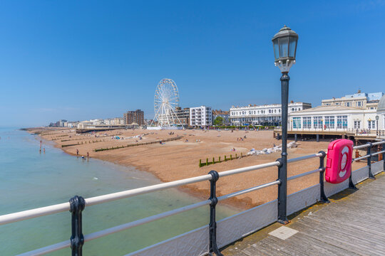 View of beach front houses and ferris wheel from the pier, Worthing, West Sussex, England