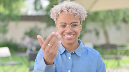 Portrait of African Woman Pointing and Inviting 