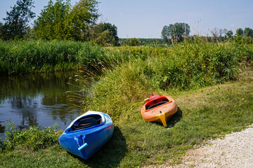 kayaks on the bank of Nida river in Poland