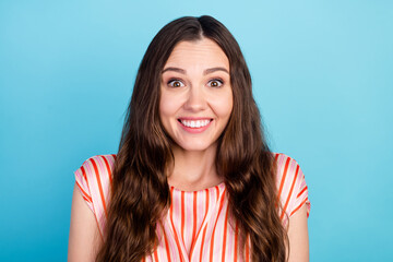 Fototapeta premium Photo of amazed adorable lady toothy beaming shiny smile wear striped blouse isolated blue color background