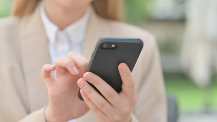 Hands Close up of Businesswoman using Smartphone 