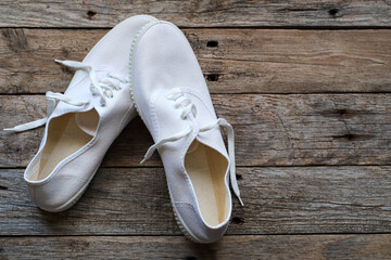 White slippers on rustic wood