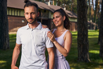 Obraz premium Calm young man accompanied by his beautiful joyous girlfriend