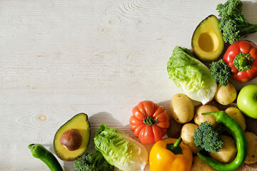 Bunch of mixed fruits, vegetables, herbs and green on white countertop. Vegan diet products. Clean eating concept. Close up, copy space, background, top view.