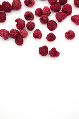Home cooked, dehydrated raspberry berries. Dried, organic raspberries. Abstract background of raspberry chips - superfood, berry fruit dessert on the white desk. 