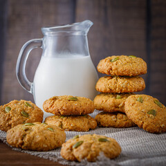 Fresh baked homemade oatmeal cookies with raisins and sunflower seeds on wooden background