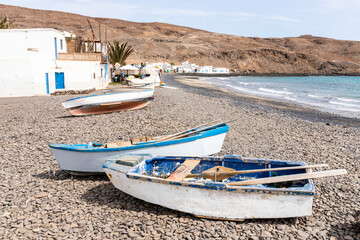 Fototapeta na wymiar Boats on the beach at Pozo Negro on the east coast of the Canary Island of Fuerteventura