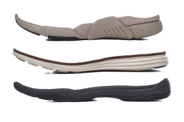 Concept Footware design or replacement parts. Three different Polyurethane rubber shoe soles on a white background.